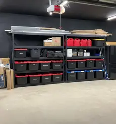 Freshly painted residential garage interior with clean black walls and organized storage system