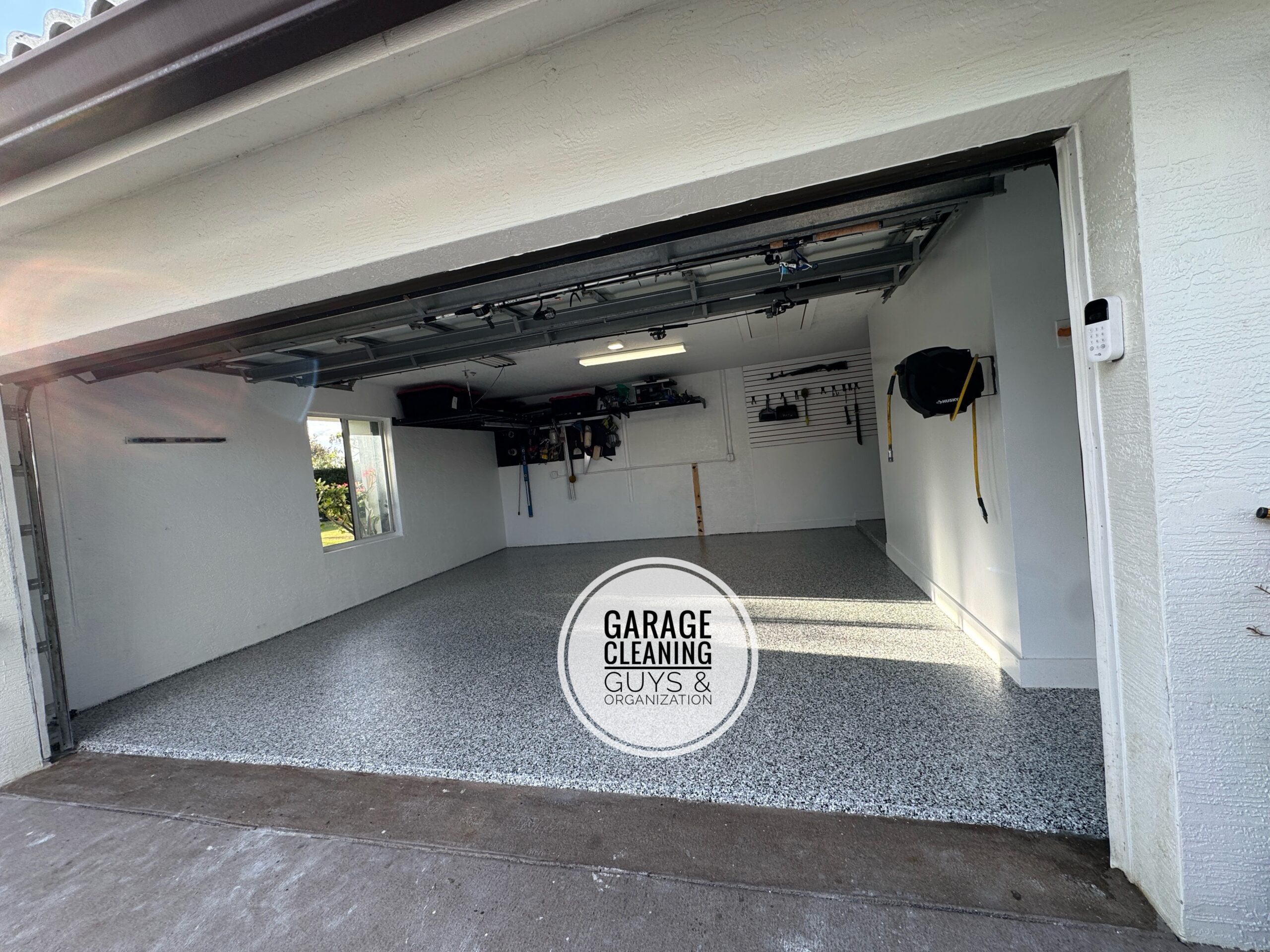 Finished organized garage with epoxy floor in Boynton Beach FL by Garage Cleaning Guys & Organization